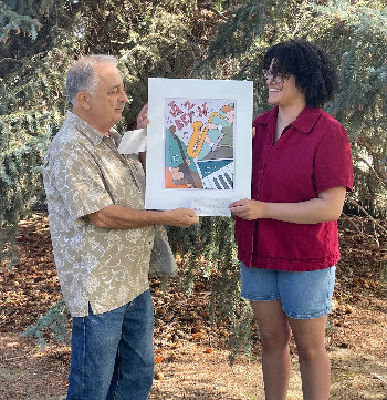 Photograph of Katelyn Legmann and Alex Cassimus with artwork and check